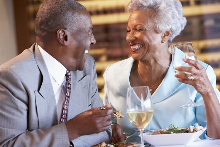 Senior couple enjoying dinner and wine.