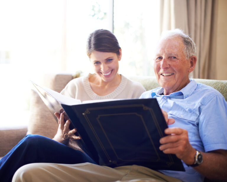 older father and daughter looking through photos
